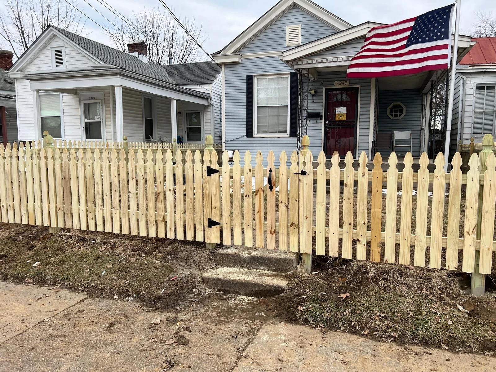 New picket fence in front of a home