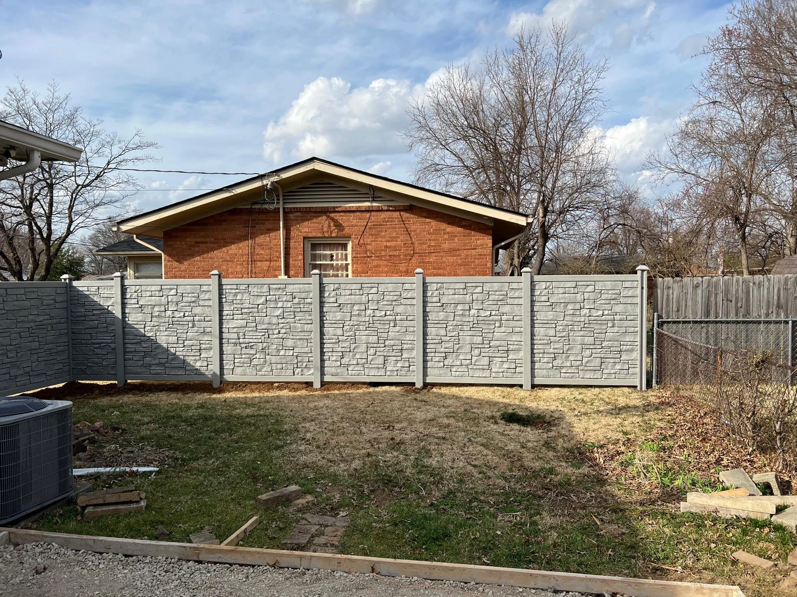 Gray privacy fence enclosing a backyard