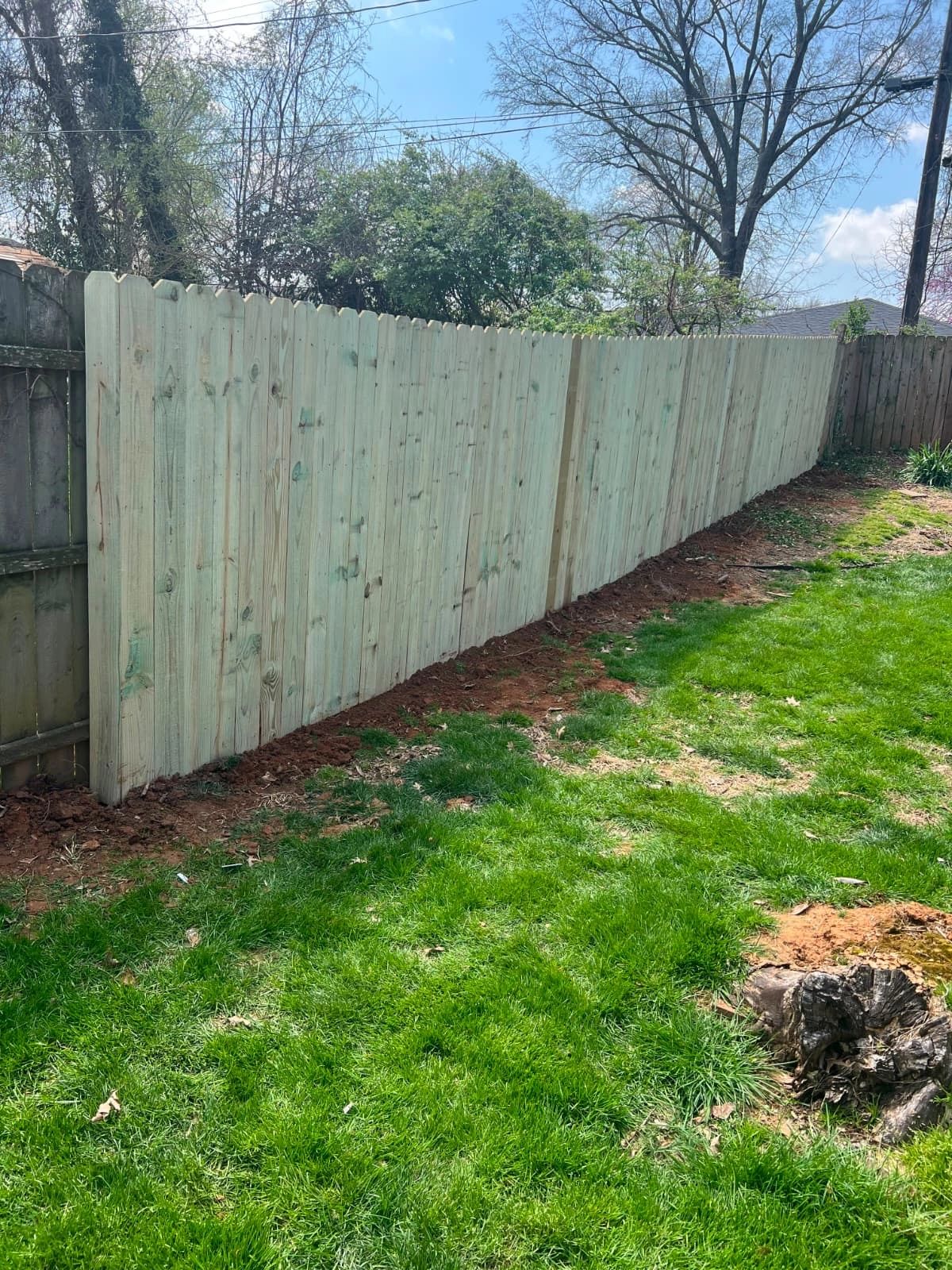 Wood privacy fence installed along a residential yard