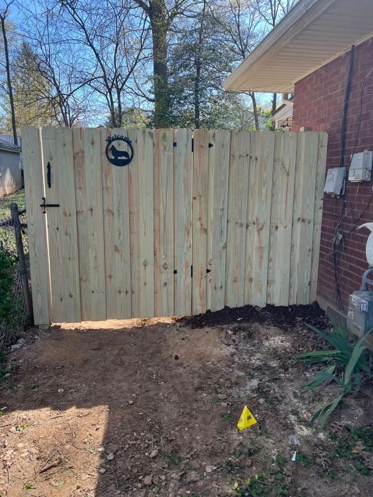 Wood side gate alongside a home